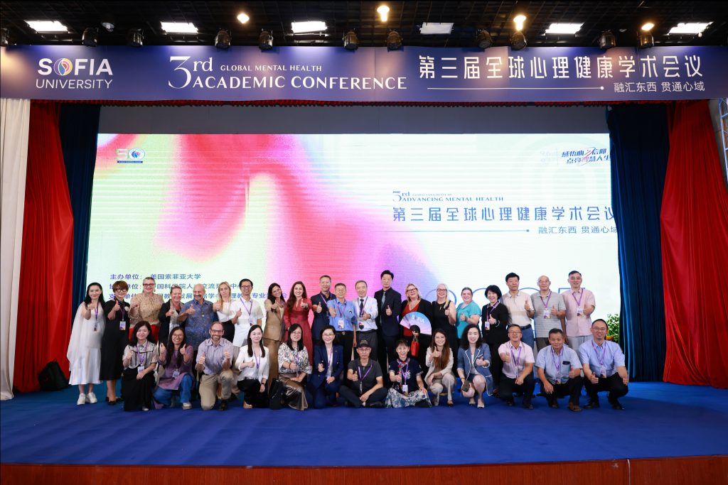 group photo on stage giving thumbs up