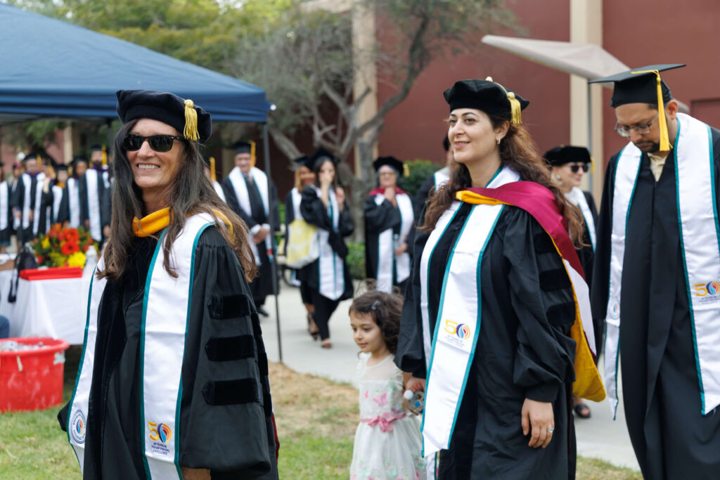 students standing in line in graduation gowns