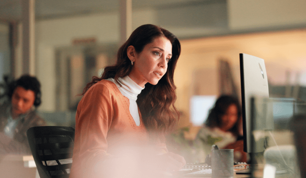 Women sitting at a desk looking at computer monitor