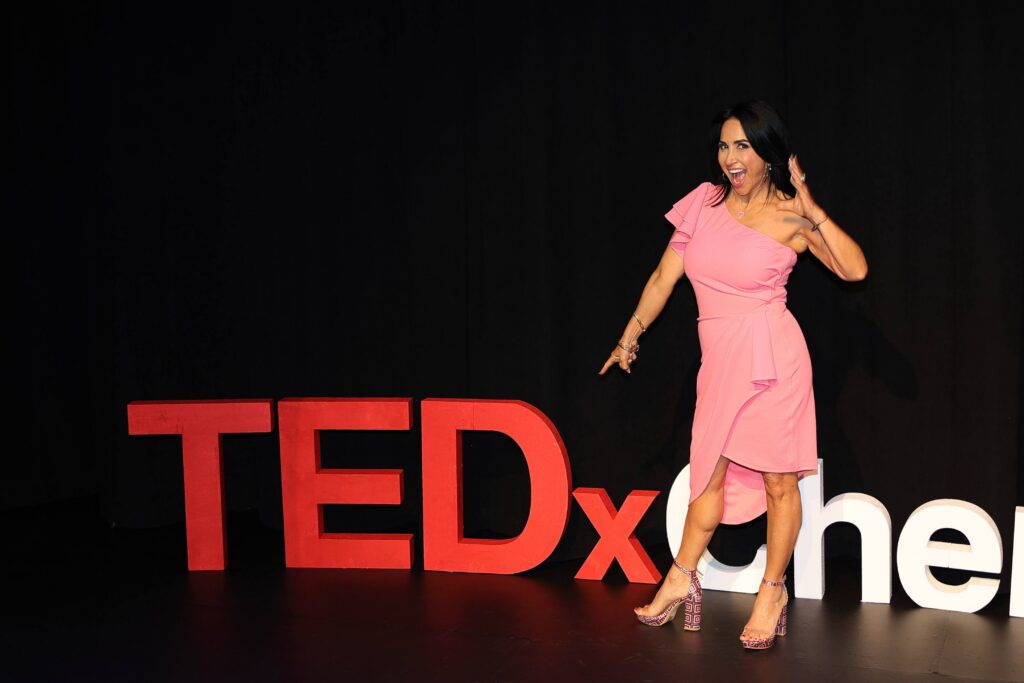 Dr. Etel Leit’s standing in front of TEDX sign - TEDx Talk