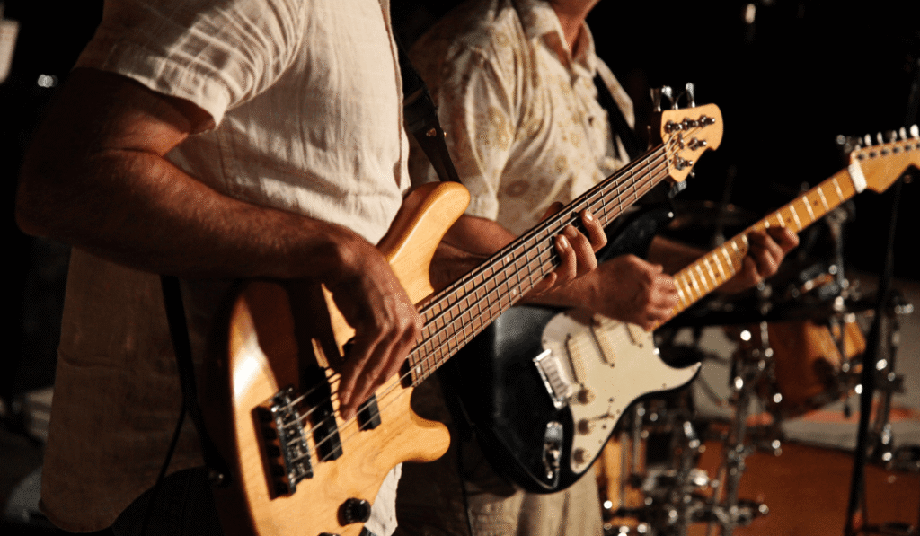 two guitar players together on stage at a concert