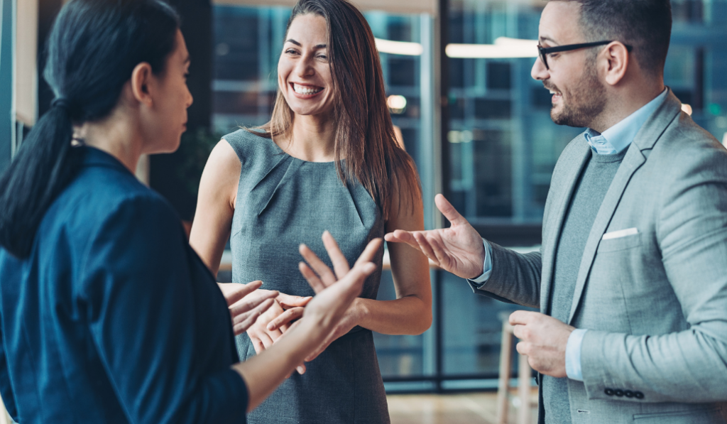 three business people chat together