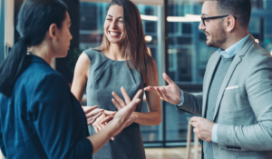 three business people chat together