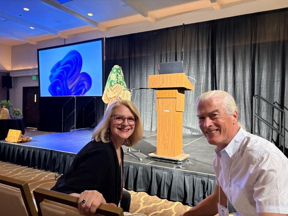 Dr. Angel Morgan and Dr. Kelly Bulkeley sitting and smiling at an event